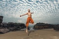 Young man high jumping on beach Royalty Free Stock Photo