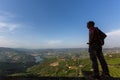 Young man hiker with backpack relaxing on top of a mountain and enjoying the view of Douro Valley Royalty Free Stock Photo