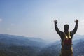 Young man hiker with backpack standing on top of a mountain Royalty Free Stock Photo