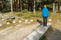 Young man hiker with stone sundial in the middle of the forest in Cercedilla, Madrid Royalty Free Stock Photo