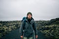 Young man hikes through rough iceland terrain