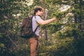 Young Man hiking in forest with backpack Travel Lifestyle Royalty Free Stock Photo