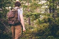 Young Man hiking in forest with backpack Travel Lifestyle Royalty Free Stock Photo