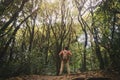 Young man hiking in majestic landscape in forest