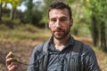 Young man hiking in the mountains, looking at a camera with a GPS in his hands. Concept of sport Royalty Free Stock Photo