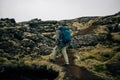 Young man hikes through rough iceland terrain