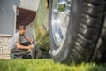 Man cleaning vintage car wheels