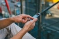 Young man hipster is holding a smartphone. A man writes a message, looks at the Internet news on his phone. Urban fast life