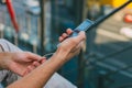 Young man hipster is holding a smartphone. A man writes a message, looks at the Internet news on his phone. Urban fast life