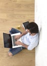 Young man in hipster modern casual style look sitting on living room home floor working on laptop Royalty Free Stock Photo