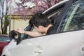 Young man in his car adjusting rear view mirror