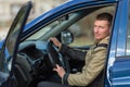 A young man in his car. Hobby. Royalty Free Stock Photo