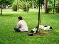 Young man and his dog rest in the grass Royalty Free Stock Photo