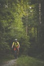 Young man with his mountain bike going for a ride past the city limits in a lovely forest Royalty Free Stock Photo
