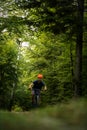 Young man with his mountain bike going for a ride past the city limits in a lovely forest Royalty Free Stock Photo