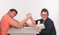 Young man and his son arm wrestling Royalty Free Stock Photo