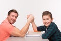 Young man and his son arm wrestling Royalty Free Stock Photo