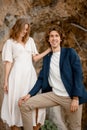 Young man and his wife are standing on the background of a steep cliff Royalty Free Stock Photo