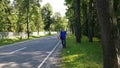 A young man hitchhiking on the side of the road. Hitching a ride