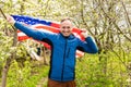 Young man holding american national flag to the sky with two hands Royalty Free Stock Photo