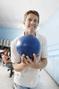 Young Man Holding Ball At Bowling Alley Royalty Free Stock Photo