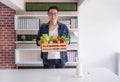 Young man holding a basket with vegetables and fruit Royalty Free Stock Photo