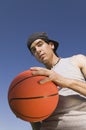 Young Man Holding Basketball low angle view.