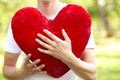 Young man holding big red heart Royalty Free Stock Photo
