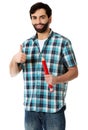 Young man holding big red pencil. Royalty Free Stock Photo