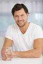 Young man holding bottle water smiling Royalty Free Stock Photo