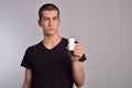 Young man holding a box of pills in his hand Royalty Free Stock Photo