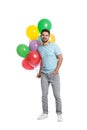 Young man holding bunch of colorful balloons Royalty Free Stock Photo