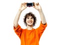 Young man holding camera photographing portrait