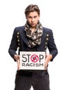 Young man holding cardboard banner with STOP RACISM message Royalty Free Stock Photo