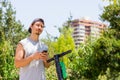 Young man holding cellphone by electric scooter at park Royalty Free Stock Photo