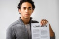 Young man holding complaints report