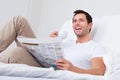 Young man holding cup in hand reading newspaper Royalty Free Stock Photo