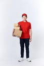 Young man holding delivery package looking positive and happy standing and smiling Royalty Free Stock Photo