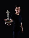 Young man holding fake oscar award