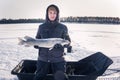 Young man holding fish catch a big pike ice fishing Royalty Free Stock Photo