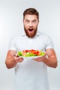 Young man holding fork to eat fresh vegetable salad meal Royalty Free Stock Photo