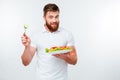 Young man holding fork to eat fresh vegetable salad meal Royalty Free Stock Photo