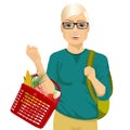 Young man holding a full shopping basket Royalty Free Stock Photo