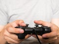 A young man holding game controller playing video games Royalty Free Stock Photo