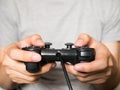 A young man holding game controller playing video games