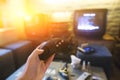 A young man holding game controller playing video games. Oldschool console. Gaming concept. Royalty Free Stock Photo