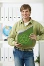 Young man holding green folder
