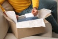 Young man holding greeting card near parcel with Christmas gift, closeup Royalty Free Stock Photo