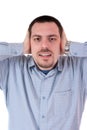 Young man holding hands on his ears, shielding Royalty Free Stock Photo