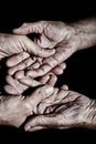 Young man holding the hands of an old woman Royalty Free Stock Photo